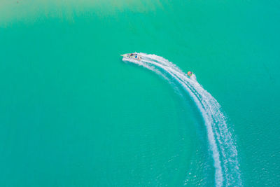 Aerial drone photo of extreme powerboat donut in tropical turquoise bay. thailand, phuket, 