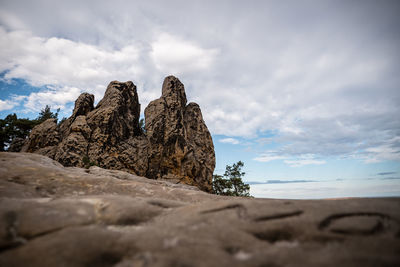 Low angle view of rocks on shore against sky