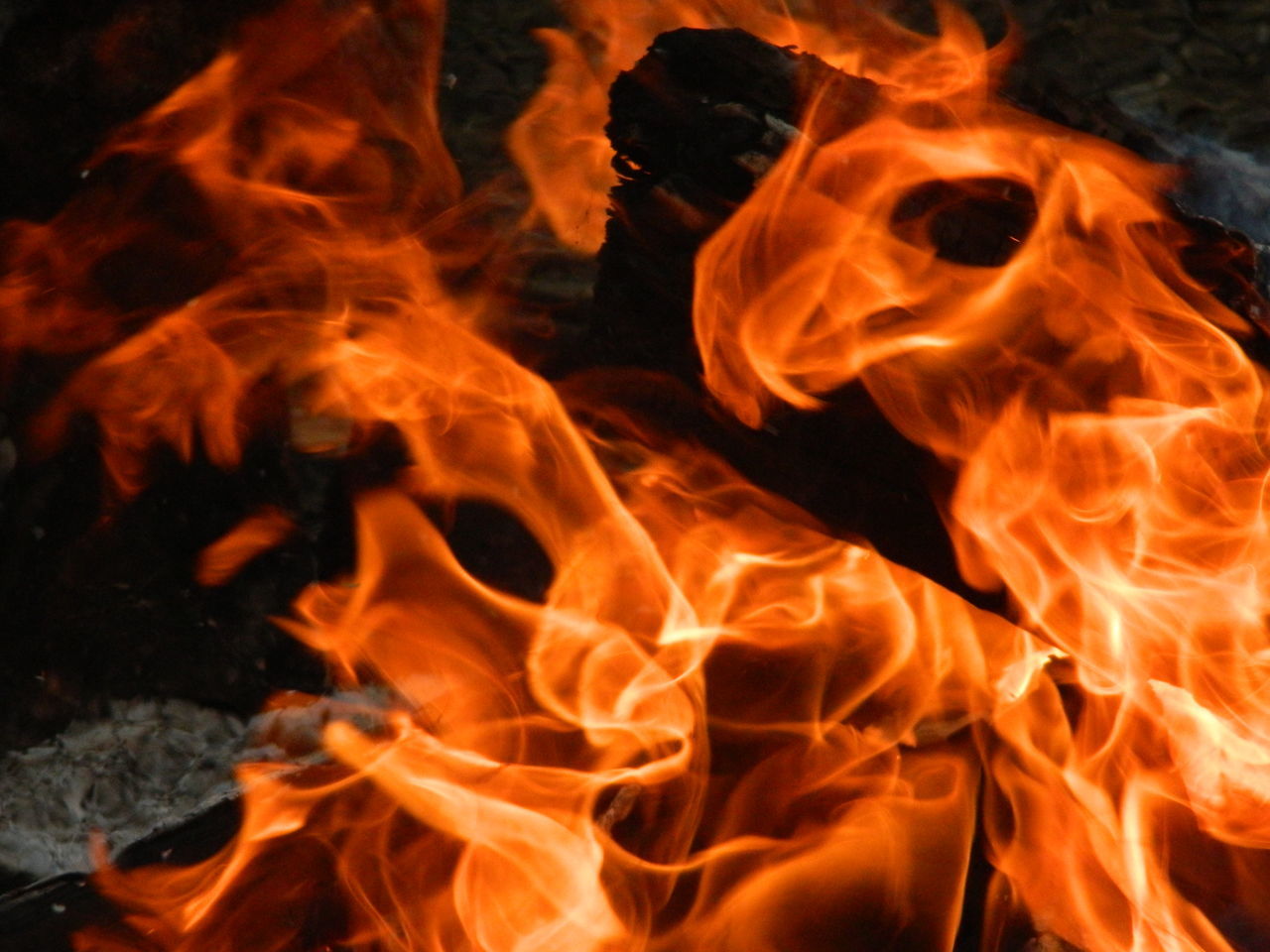 burning, flame, heat - temperature, fire - natural phenomenon, bonfire, glowing, firewood, night, campfire, close-up, orange color, fire, heat, motion, no people, outdoors, yellow, light - natural phenomenon, dark, backgrounds