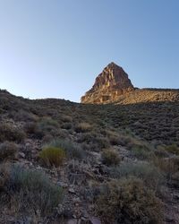 Rock formations on landscape against clear sky