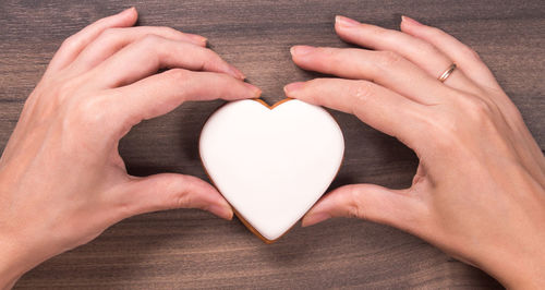 Cropped image of person holding heart shape