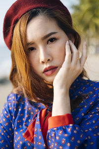 Close-up portrait of young woman standing outdoors