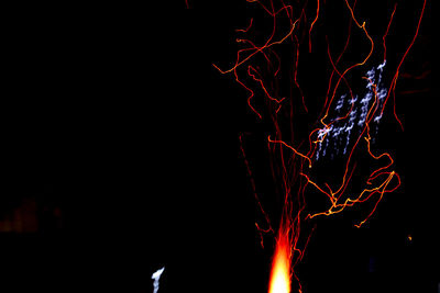 Close-up of illuminated fire against black background