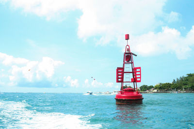 Photograph of buoy on the water used to detect tsunamis while sailing by boat on ahot morning, bali.