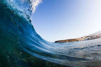 Close-up of waves on sea against clear sky