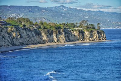 Scenic view of sea and rocks against sky