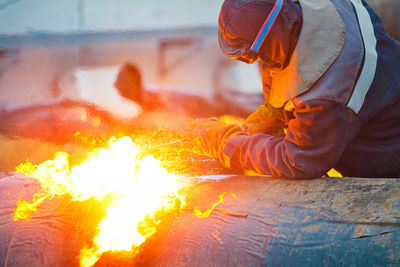 Man working on bonfire