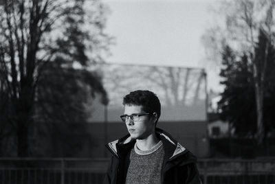 Boy standing against trees