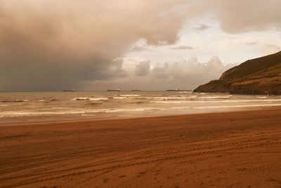 Scenic view of beach against sky during sunset
