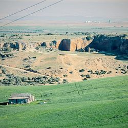 Scenic view of field against cloudy sky