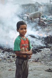 Portrait of boy standing on ground