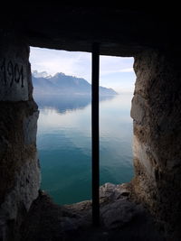 Scenic view of lake seen through mountains