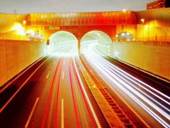 Light trails on road in illuminated tunnel
