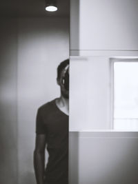 Side view of man standing on wall