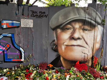 Portrait of man with red flowers