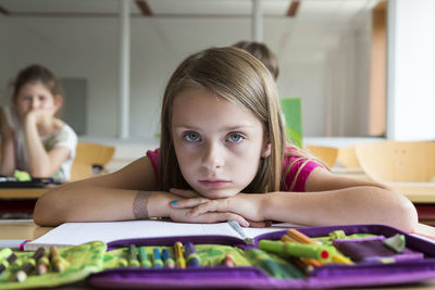 Portrait of bored schoolgirl at class