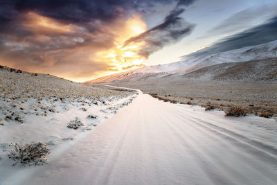 Scenic view of snow covered landscape against sky