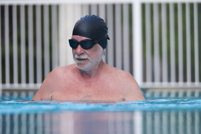 Portrait of man wearing sunglasses at swimming pool