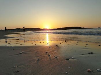 Scenic view of beach against sky during sunset