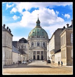 Facade of church against cloudy sky