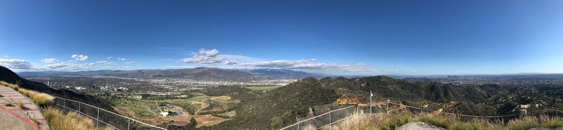 Panoramic view of landscape against blue sky