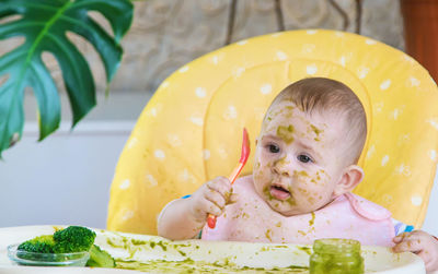 High angle view of cute baby boy sitting on table