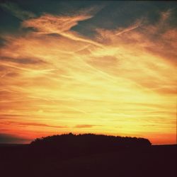 Scenic view of landscape against sky at sunset