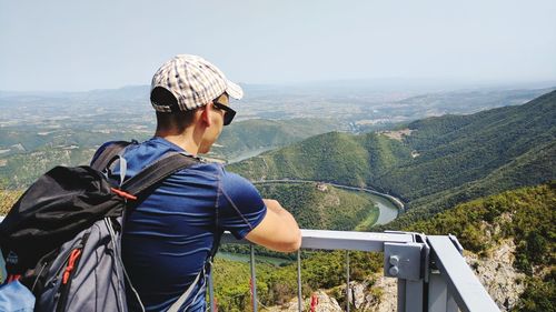 Man on mountain against clear sky