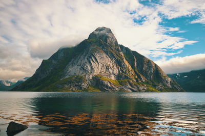 Scenic view of lake by mountain against sky