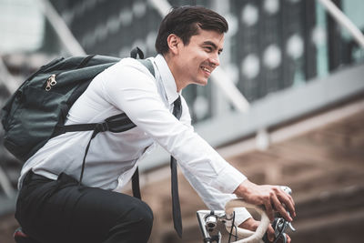 Young man riding bicycle