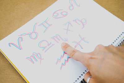 Cropped hand of person writing on paper