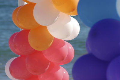 Close-up of colorful balloons at beach