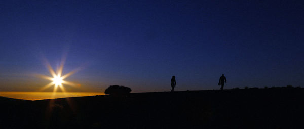 Silhouette woman against clear sky during sunset