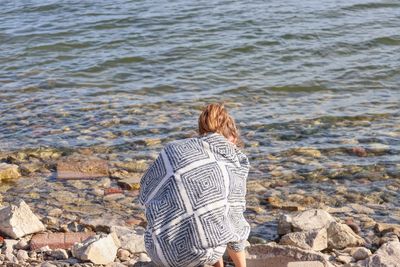 Rear view of woman looking at sea shore
