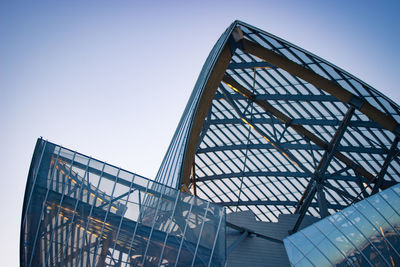 Low angle view of modern building against clear blue sky