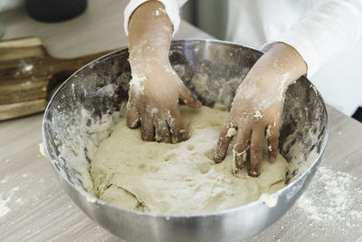 Close-up of person preparing food in bowl