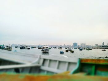 Boats in sea against clear sky