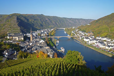 High angle view of agricultural field and village against clear sky