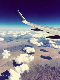 Cropped image of airplane flying over landscape