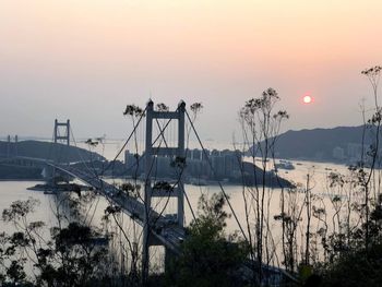 Scenic view of tsing yi bridge against sky during sunset