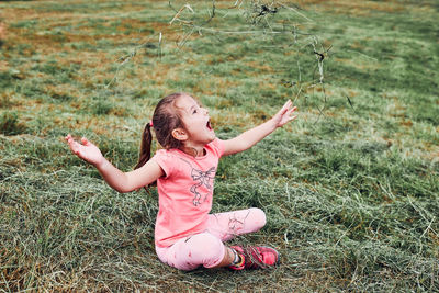 Full length of a girl lying on field