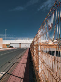 Rusty fence, empty street