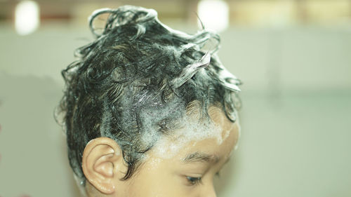 Close-up of baby boy with soap sud on hair