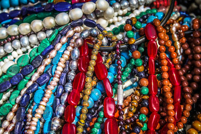 Close-up of multi colored jewelry for sale in market