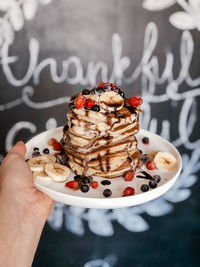 Close-up of hand holding cake