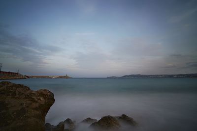 Scenic view of sea against sky at dusk