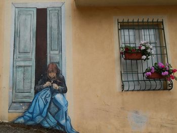 Woman with flowers on window