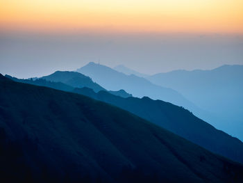 Scenic view of mountains against sky at sunset