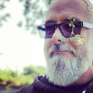 Portrait of man with red flower