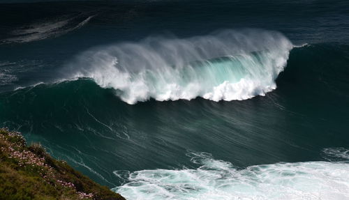 High angle view of waves splashing on sea